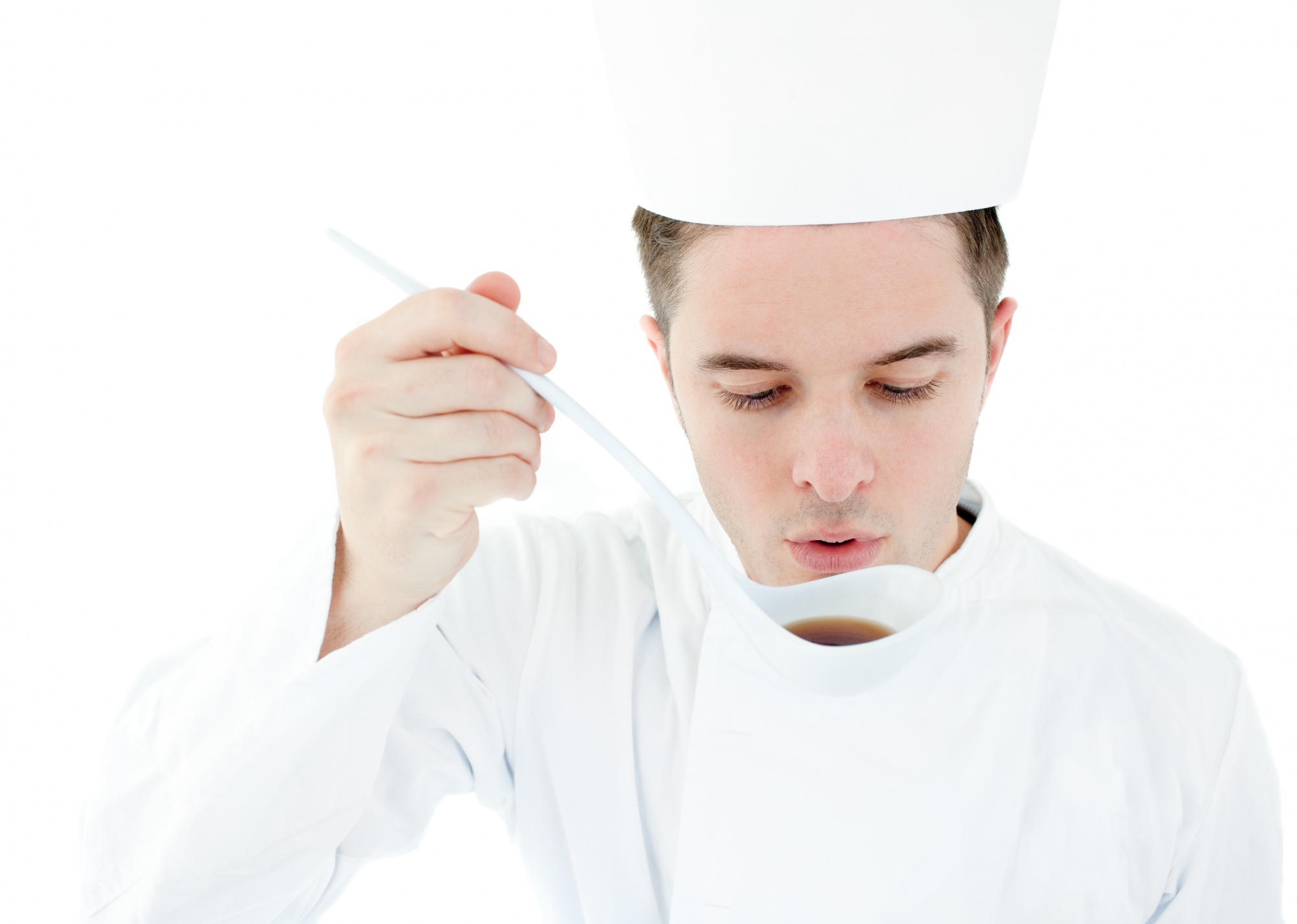 Chef demonstrating a cooking technique to a small group