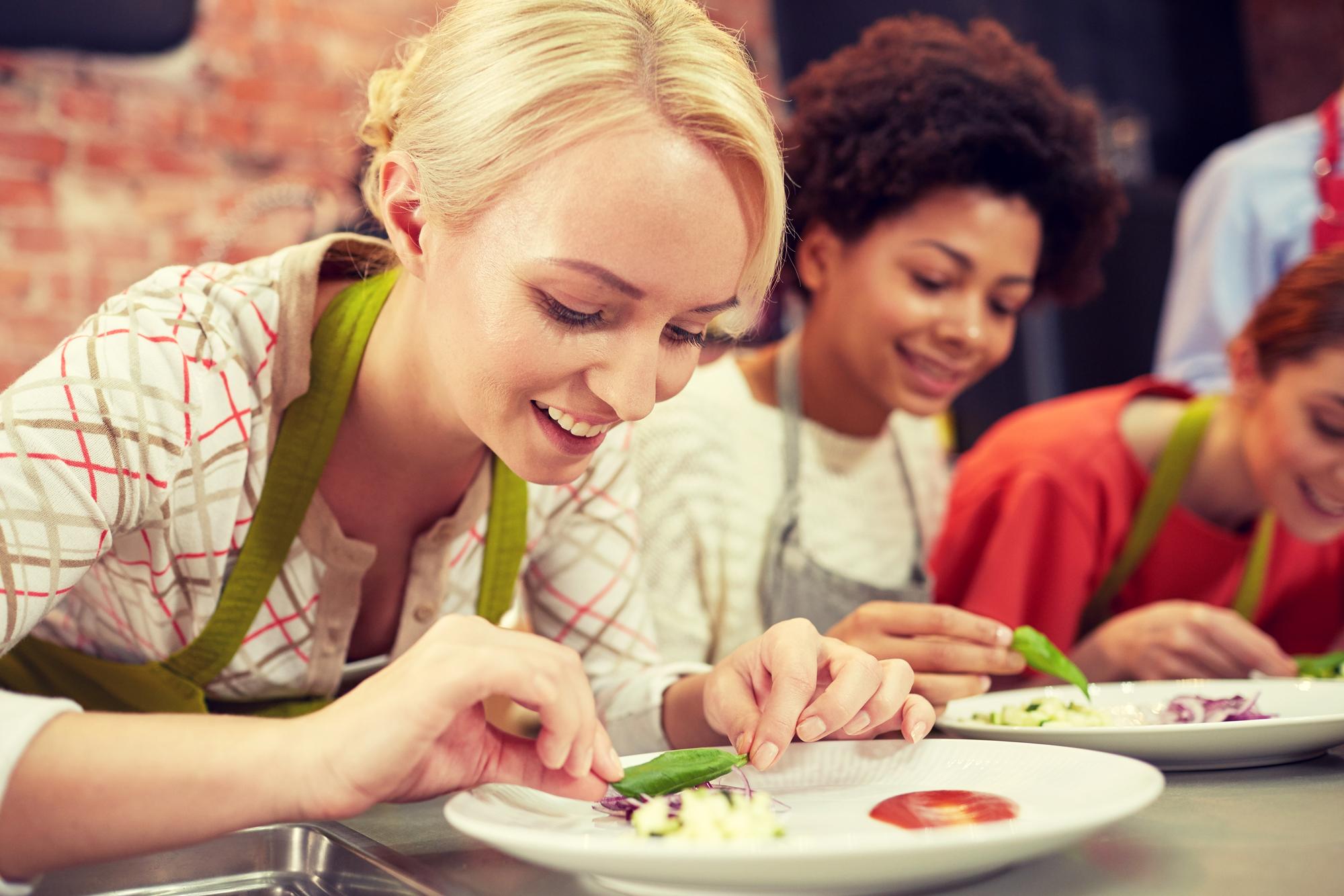 Students tasting and taking notes around table
